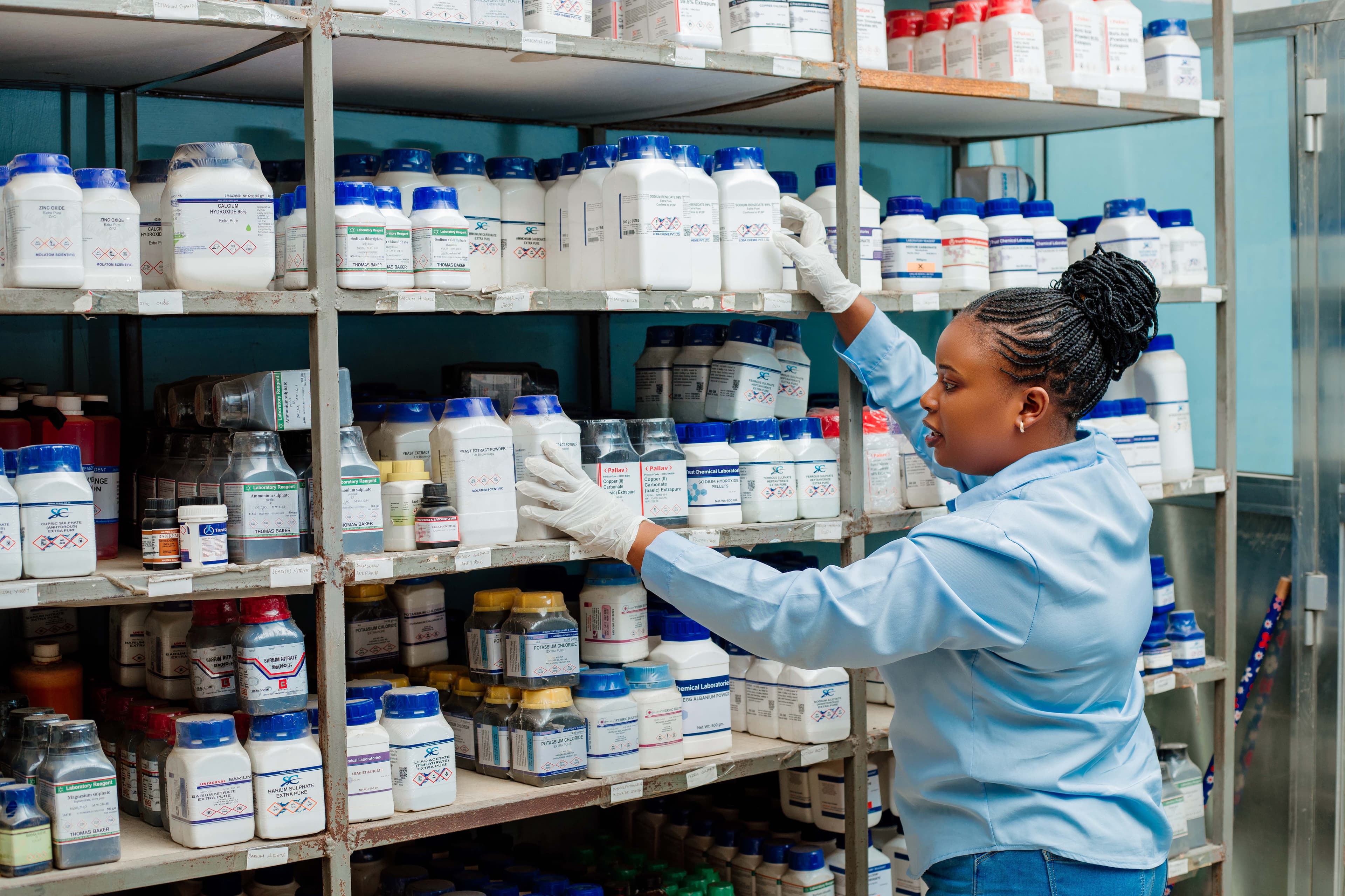 Waja Chemicals team member handling laboratory reagent stock
